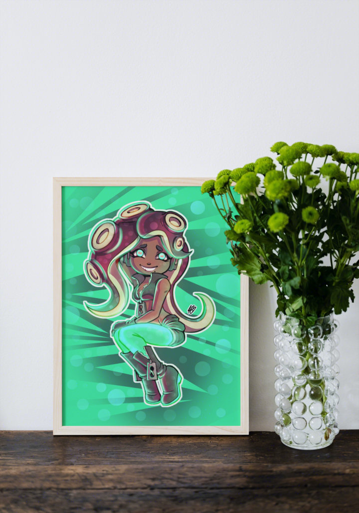  The aforementioned illustration of Marina displayed in a mock-up frame for real life reference. it's in a white frame, placed upon a brown table, and leaning against a white wall. To the right of the frame is a glass vase with green flowers in it.