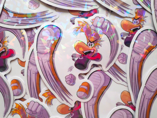 Holographic sticker of Rayman doing a punch and kick attack while smiling with an open mouth triumphantly.