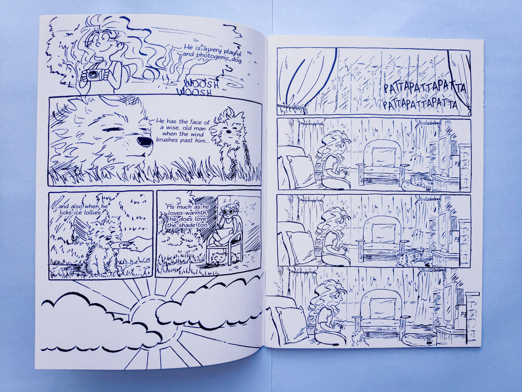 A preview of the inside pages of Das My Bai. Illustrated in black and white, one page shows a sunny but raining day of myself feeding my dog an ice lolly, and the next page shows a rainy day, and I'm inside playing video games while my dog comes over to me. The book is placed against a light blue background.