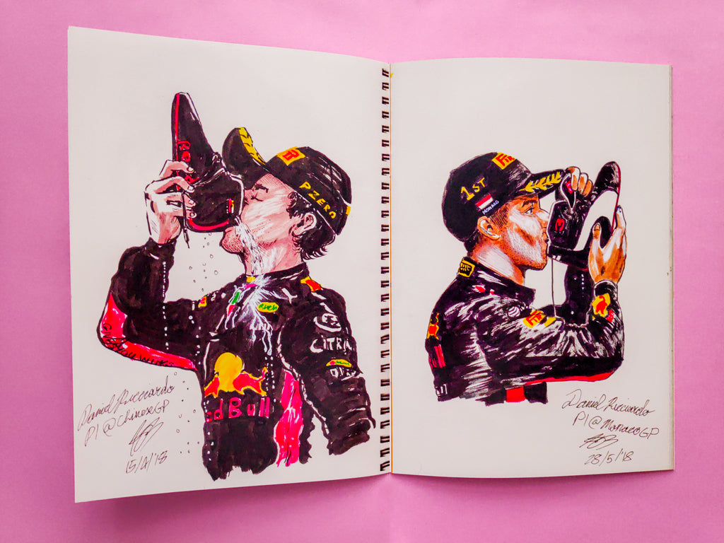 A copy of the Daniel Ricciardo art book opened out, showing 2 pages inside. The pages show an ink sketch illustration each of various shoeys that Ricciardo celebrated during his time at Red Bull.