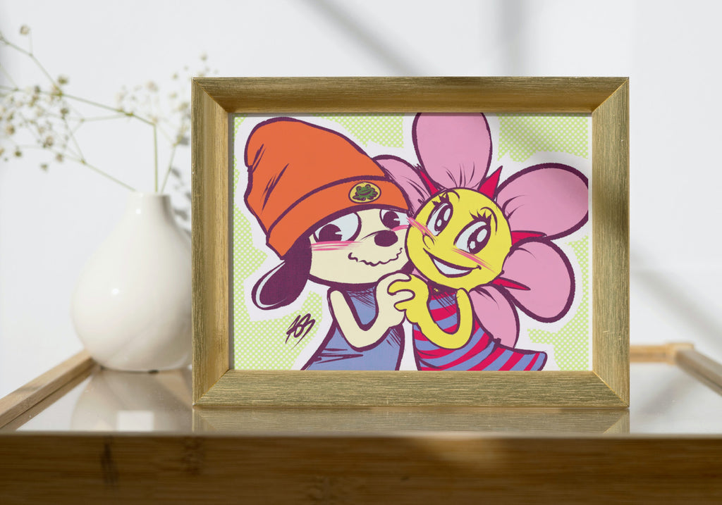 The aformentioned Parappa and Sunny Funny illustration shown in a mock-up display frame for real life reference. It's in a small wooden frame, placed upon a wodden table with a glass top. There's a white vase of baby's breath behind it.