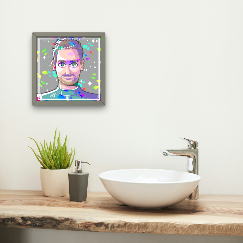 The aforementioned Vettel illustration shown in a mock up frame hanging on a white wall. A hand wash sink with hand wash and a plant is seen in the foreground.